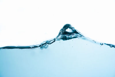 Close-up of water splashing against white background