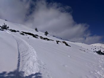 Scenic view of snow covered mountains against sky