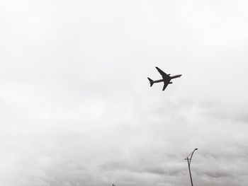 Low angle view of airplane flying in sky