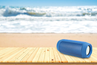 Deck chair on beach against sea