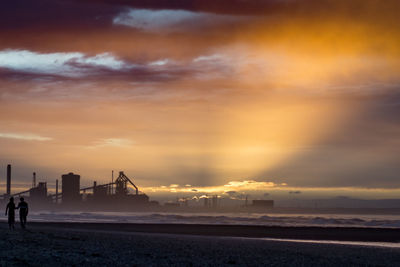 Scenic view of beach against sky during sunset