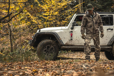 Rear view of man standing in forest