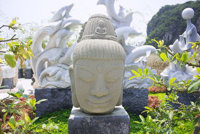 Statue of buddha against plants