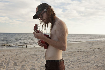 Young man hanging out on a beach