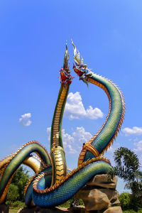 Low angle view of horse against blue sky