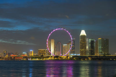 Singapore ferris wheel and business district and city, marina bay  singapore on february 2, 2020.