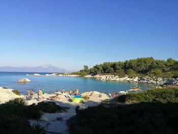 Scenic view of beach against clear blue sky