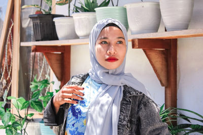 Portrait of young woman standing outdoors