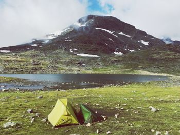 Scenic view of lake and mountains against sky