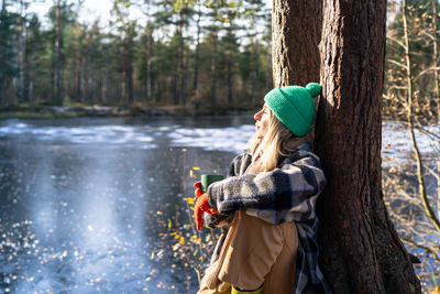 Rear view of woman standing in forest