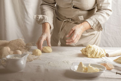 Midsection of man preparing food on table