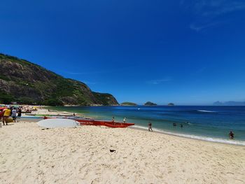 Scenic view of beach against blue sky