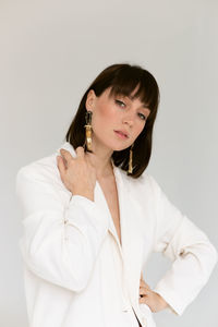 Young woman standing against white background