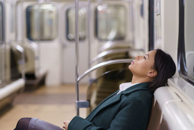 Tired african businesswoman in subway train afro female office worker return home after hard workday