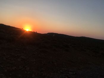 Scenic view of silhouette landscape against clear sky during sunset