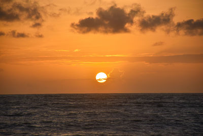 Scenic view of sea against orange sky