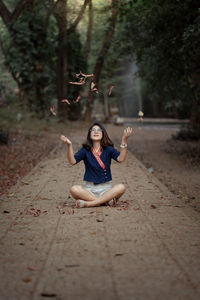 Portrait of a young woman sitting in park