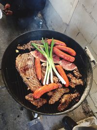 High angle view of meat cooking on barbecue grill