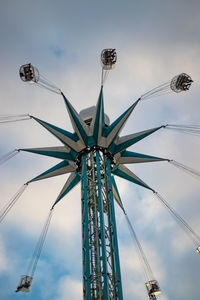 Low angle view of chain swing ride against sky