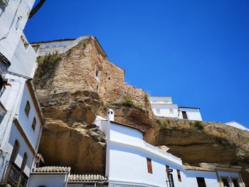 Low angle view of historic building against clear blue sky