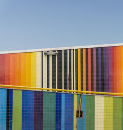 Close-up of multi colored building against blue sky