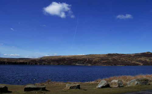 Scenic view of lake against blue sky