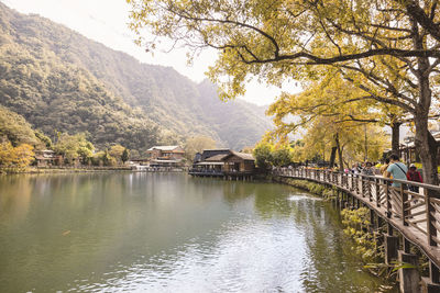 Bridge over river amidst buildings and trees