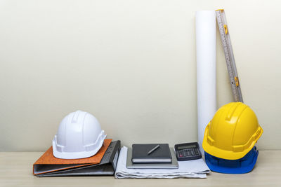Hardhats and files against wall