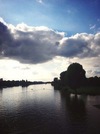 View of calm lake against cloudy sky