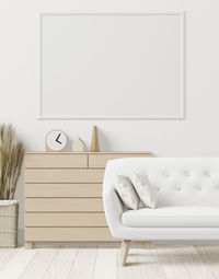 Empty chair against white wall at home