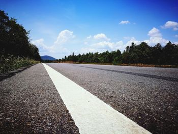 Empty road against blue sky