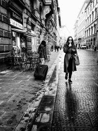 Woman standing on city street