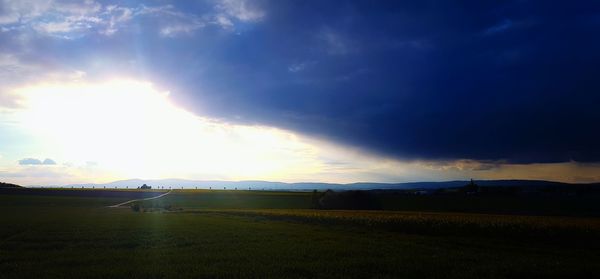 Scenic view of field against sky during sunset