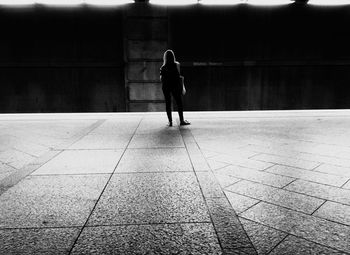 Rear view of woman walking on footpath