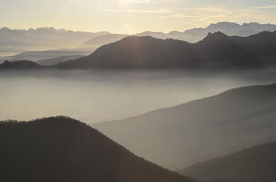 Scenic view of silhouette mountains against sky during sunset