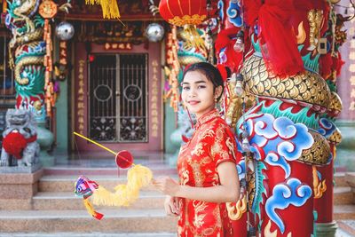 Portrait of girl standing against temple