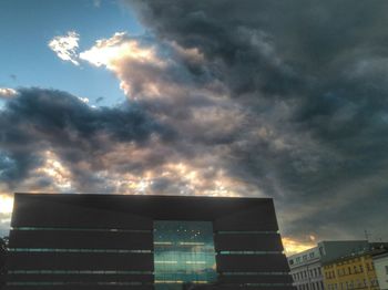 Low angle view of building against cloudy sky
