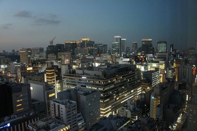 Illuminated cityscape against sky