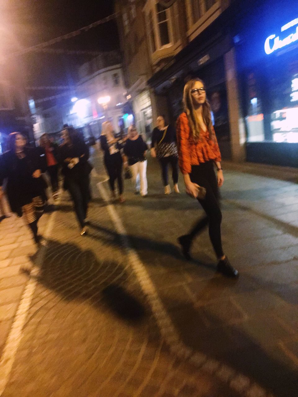 city, night, motion, walking, real people, blurred motion, street, illuminated, full length, women, lifestyles, architecture, group of people, shadow, city life, people, adult, transportation, men, built structure, outdoors