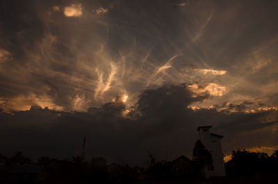 Low angle view of silhouette buildings against sky during sunset