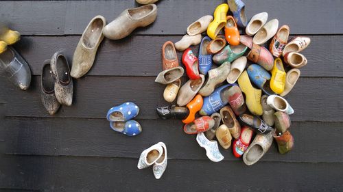 Large group of traditional wooden shoes on wooden planks