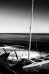 Sailboat sailing on sea against clear sky