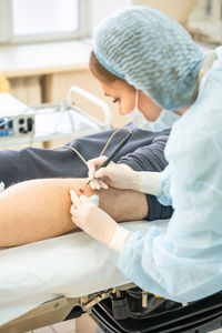 Side view of doctor examining patient at home