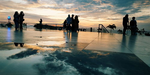 Silhouette people against sky during sunset