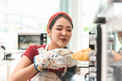 Happy chef preparing food in microwave