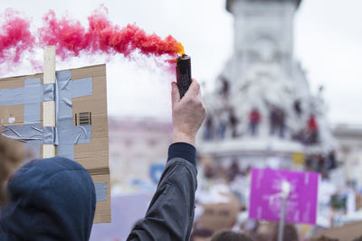 Cropped hand of man holding distress flare