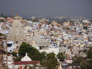 Aerial view of townscape against sky in city