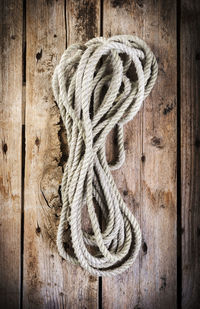 Close-up of rope tied on wooden door