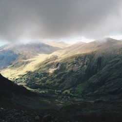 Scenic view of mountains against cloudy sky