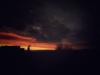 Silhouette landscape against sky during sunset